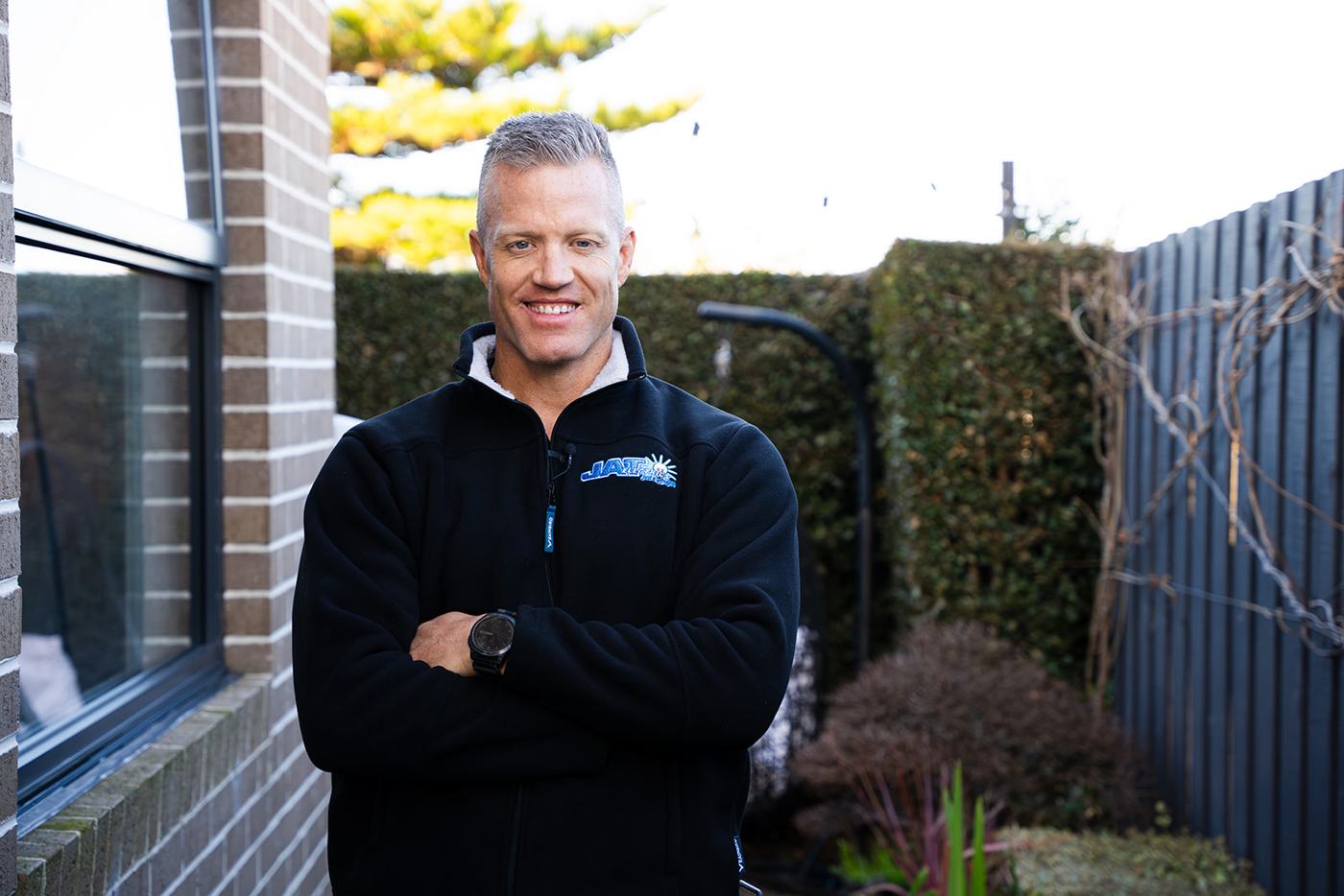 Lance from JAT Electrics, arms crossed, smiling